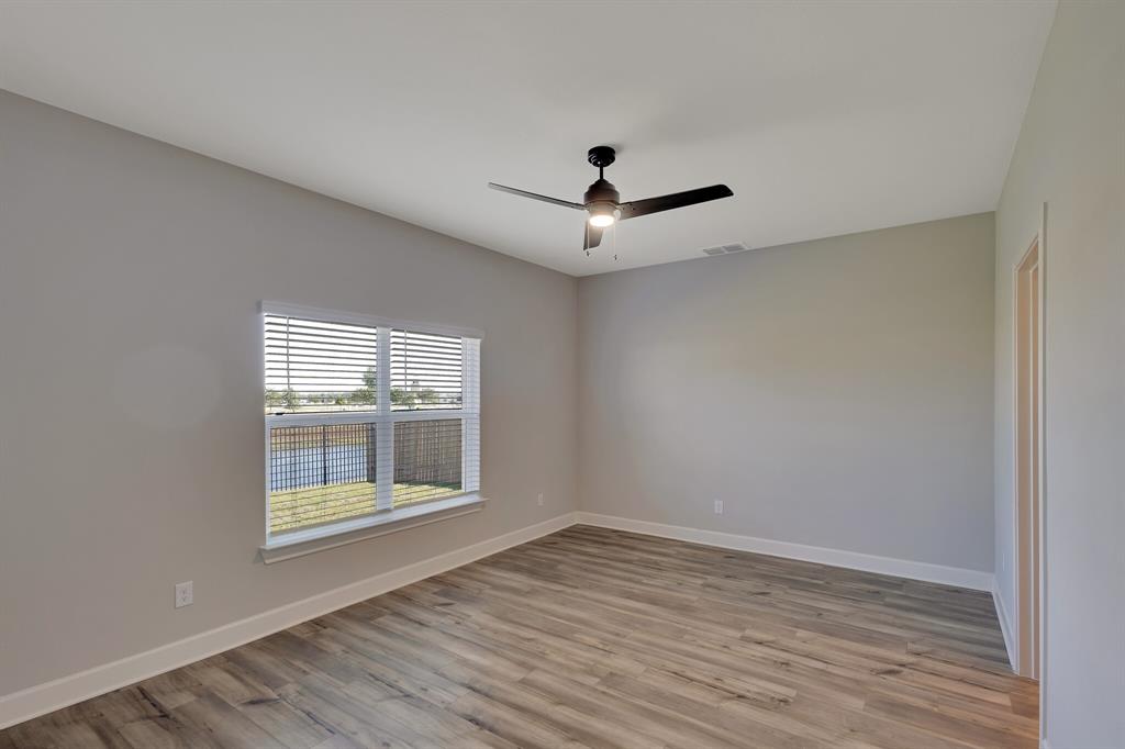 1816 Jeanine Drive Anna, TX 75409 - Photo 10 of 23 a view of empty room with wooden floor and fan