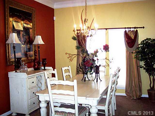 3102 Spring Fancy Lane Indian Trail, NC 28079 - Photo 4 of 11 a view of a dining room with furniture and chandelier