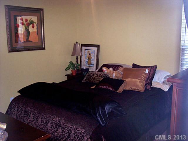 3102 Spring Fancy Lane Indian Trail, NC 28079 - Photo 10 of 11 a bed sitting in a bedroom next to a lamp