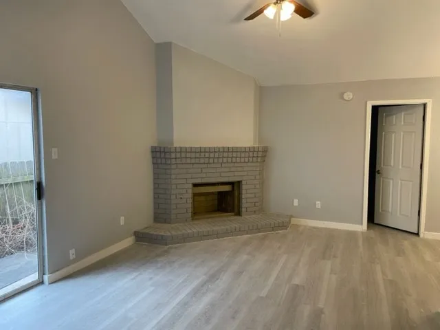 wooden floor fireplace and natural light in room