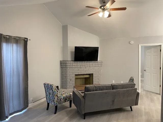 a kitchen with stainless steel appliances granite countertop a sink a stove and a wooden floors