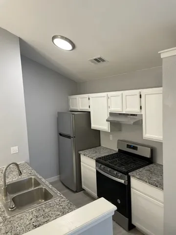 a kitchen with granite countertop lots of counter top space