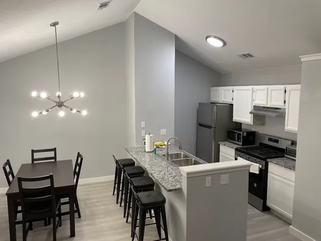 a kitchen with a sink stove and refrigerator