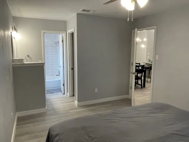 a bedroom with a bed and a chandelier