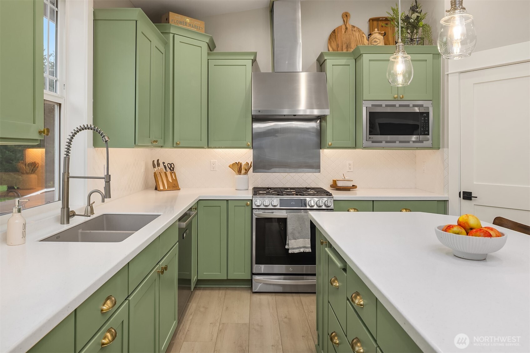 6937 Lake Alice Road Southeast Fall City, WA 98024 - Photo 11 of 39 a kitchen with a sink and a stove top oven with wooden floor