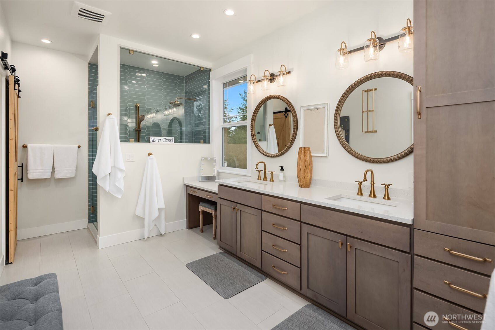 6937 Lake Alice Road Southeast Fall City, WA 98024 - Photo 20 of 39 a bathroom with a double vanity sink a toilet and a mirror