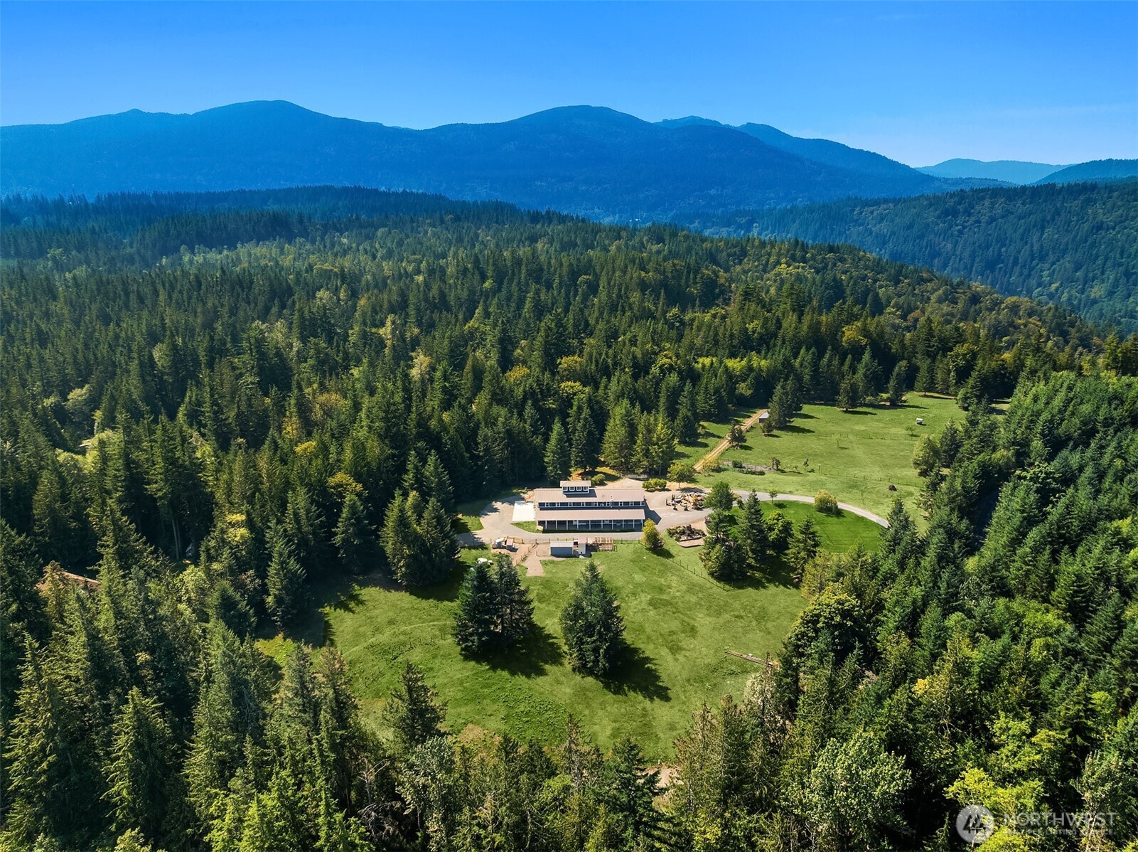 6937 Lake Alice Road Southeast Fall City, WA 98024 - Photo 38 of 39 a view of a lush green hillside and a building