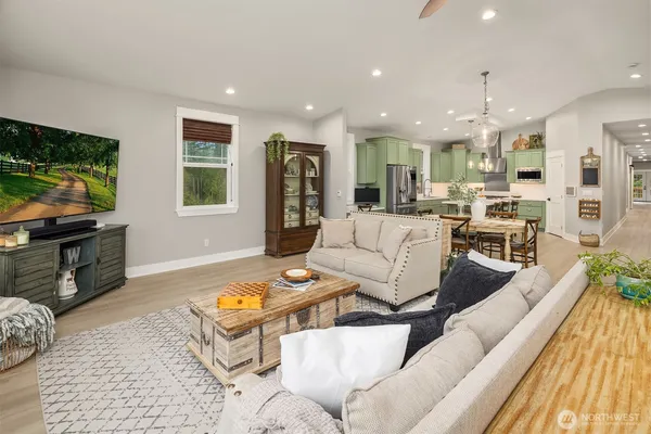 a living room with furniture fireplace and a window