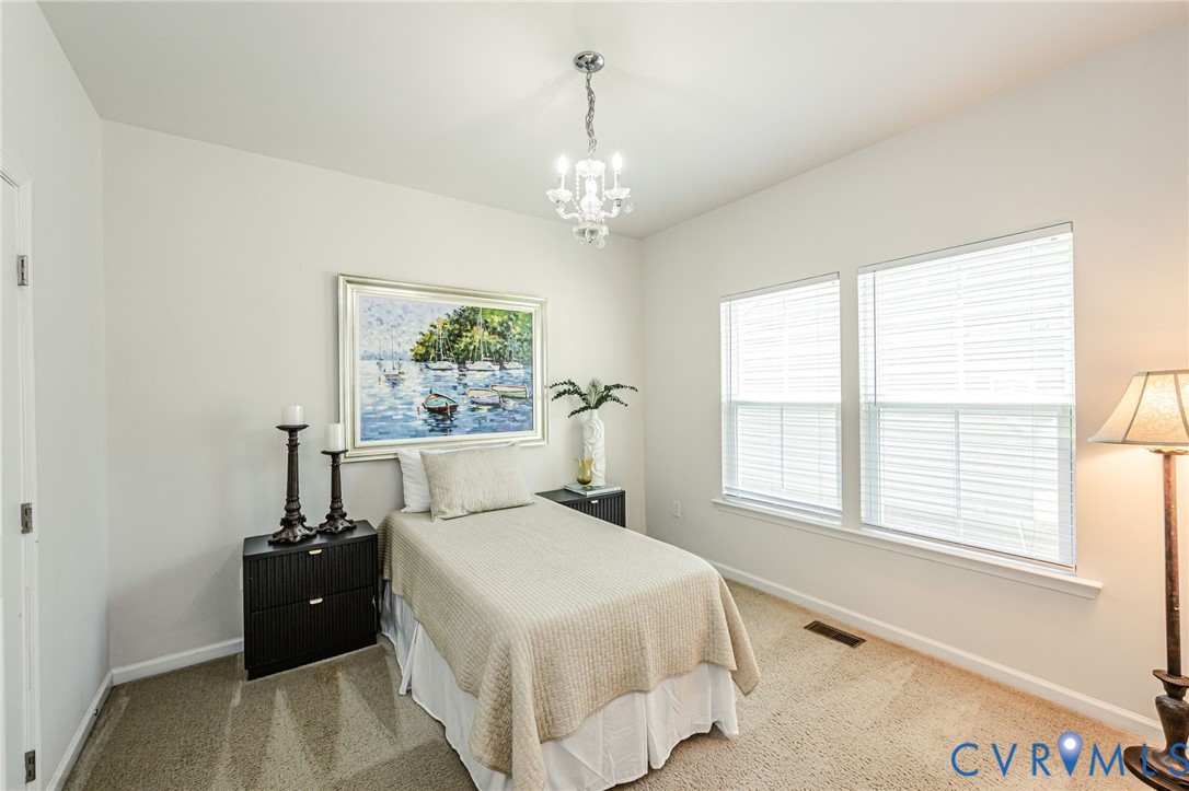 7435 Wicks Road Williamsburg, VA 23188 - Photo 56 of 82 Bright bedroom 3 featuring two large windows with