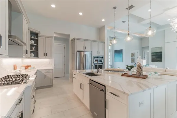 a kitchen with a sink stove and refrigerator