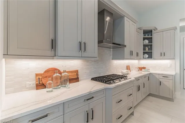 a kitchen with white cabinets and appliances