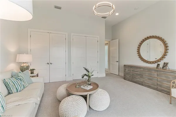 a living room with furniture a mirror and a table