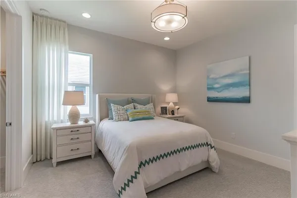 a bedroom with a large bed and a window