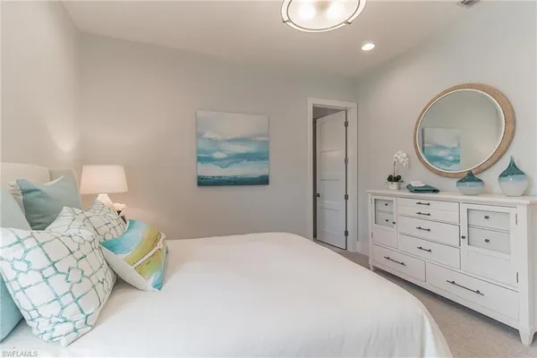 a bedroom with a bed and a dresser