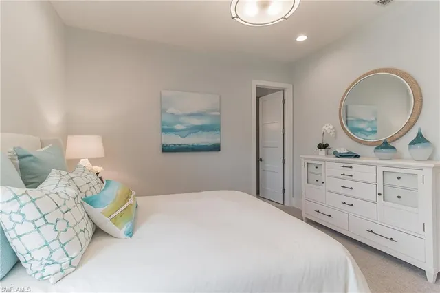 a bedroom with a bed and a dresser