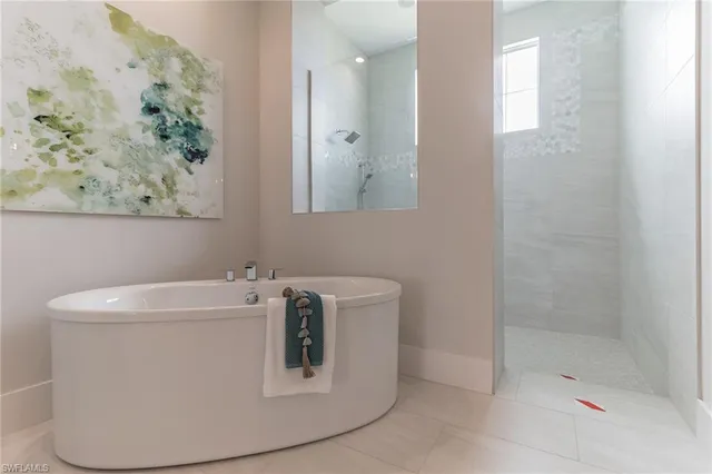 a white bath tub sitting next to a white sink