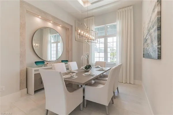 a dining room with furniture a mirror and a bathtub