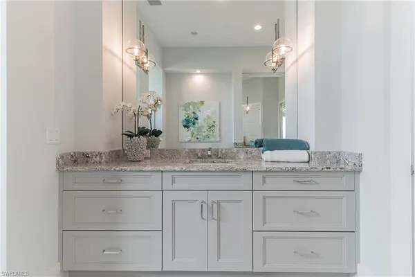 a bathroom with a sink vanity and a mirror