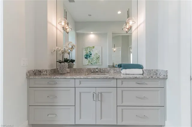 a bathroom with a sink vanity and a mirror