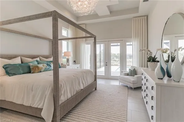 a bedroom with a bed a large window with the outer view