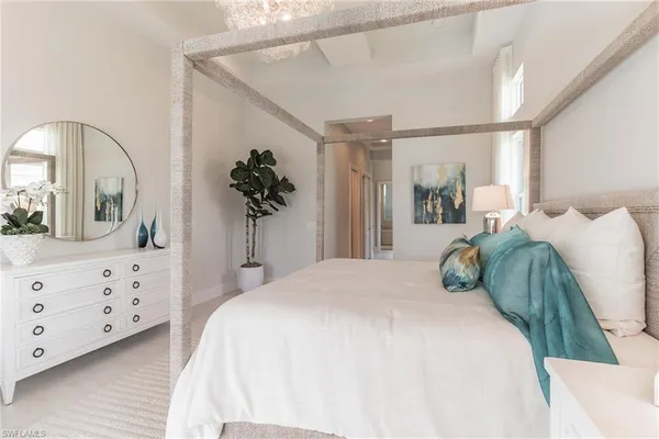 a bedroom with a bed and a dresser