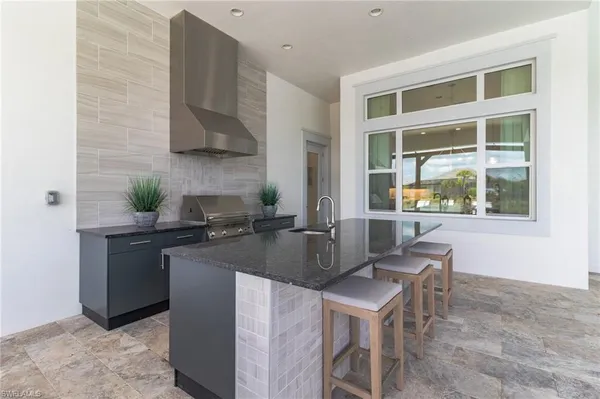 a kitchen with a stove a sink and a refrigerator