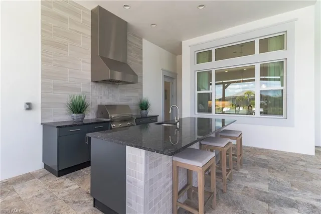 a kitchen with a stove a sink and a refrigerator