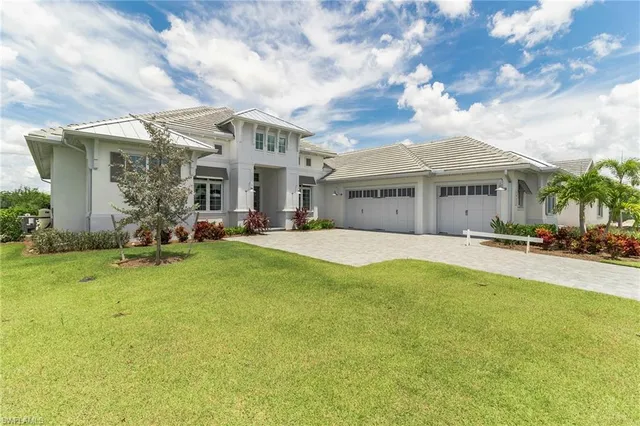 a front view of house with yard and green space