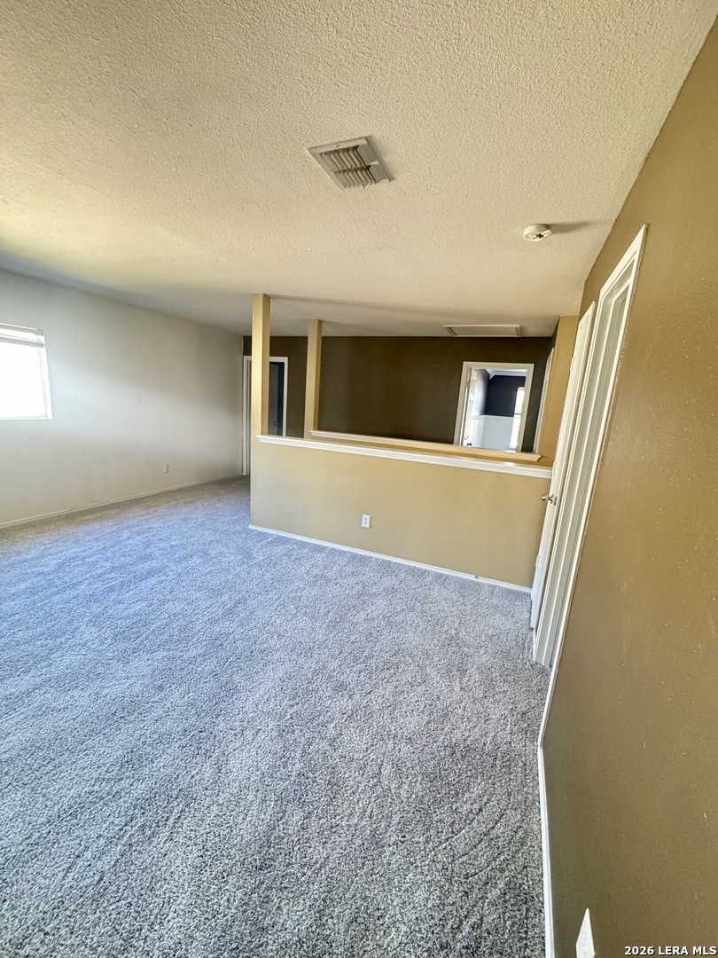 7906 Belmont Ridge Selma, TX 78154 - Photo 12 of 22 a view of an empty room with wooden floor and a window