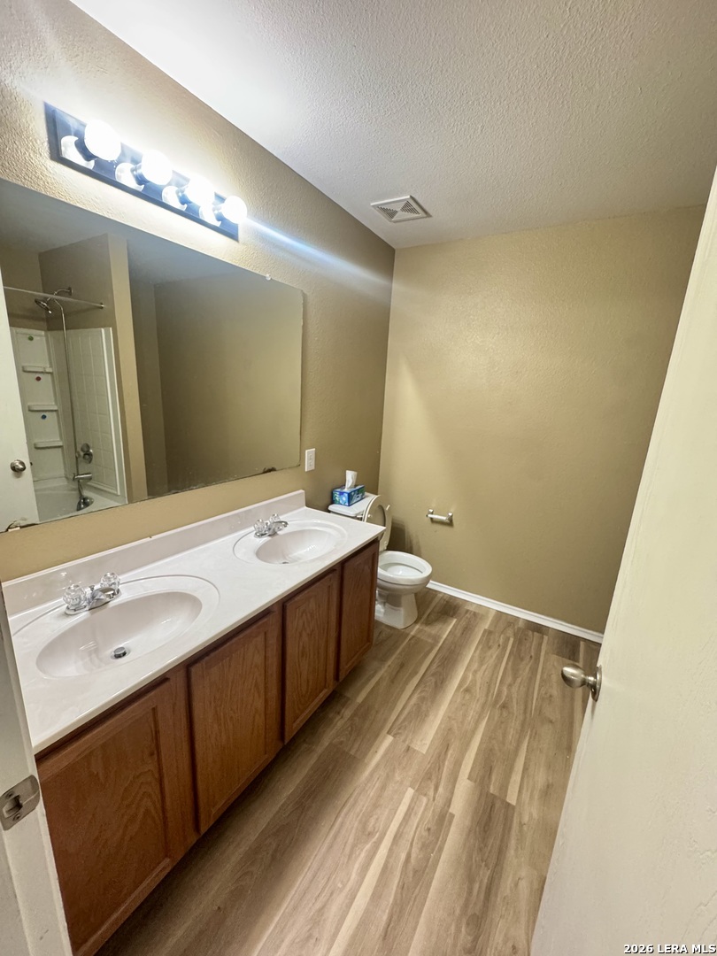 7906 Belmont Ridge Selma, TX 78154 - Photo 13 of 22 a bathroom with a double vanity sink a mirror and a shower