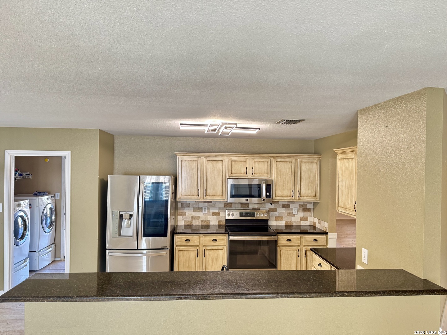 7906 Belmont Ridge Selma, TX 78154 - Photo 6 of 22 a kitchen with stainless steel appliances granite countertop a refrigerator and a stove top oven
