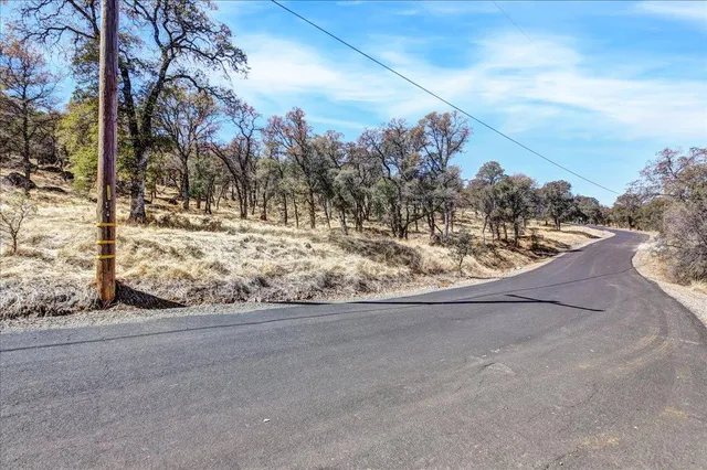 a view of a yard covered with snow in front of house