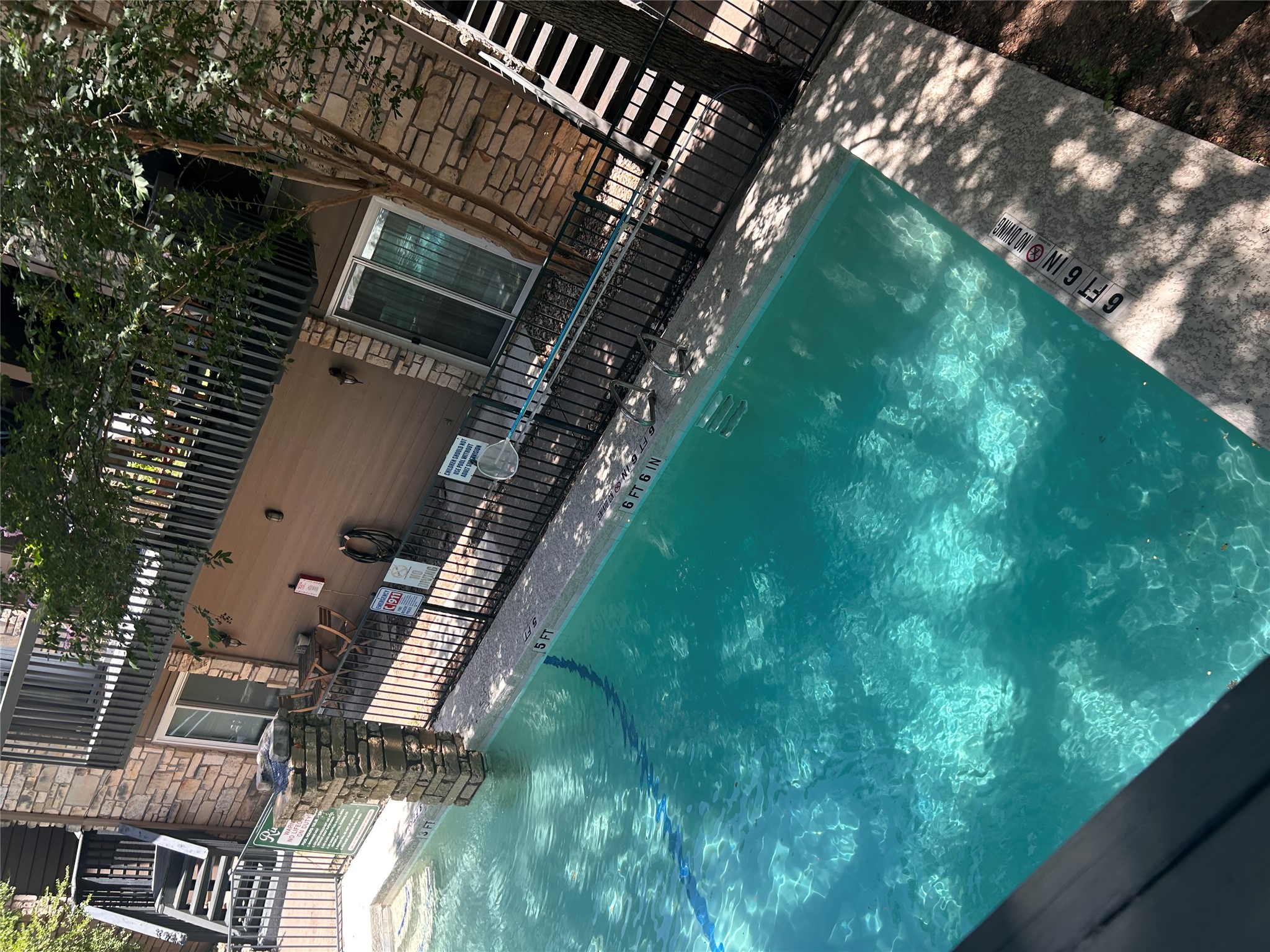 3627 Menchaca Road, Unit 204 Austin, TX 78704 - Photo 10 of 23 A sparkling pool invites relaxation, set against a backdrop of stone and wood-sided building exteriors. View from your balcony.