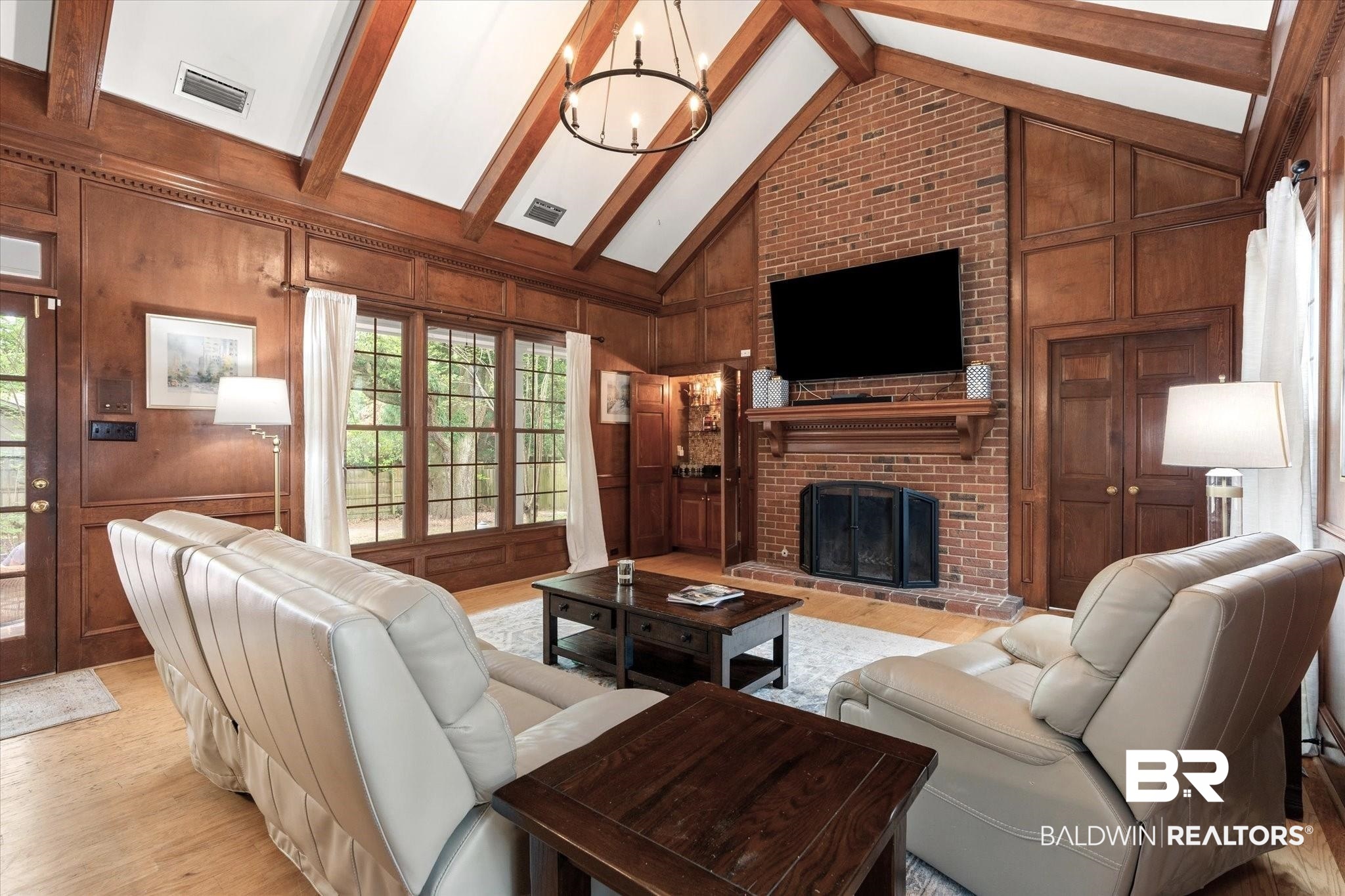 5324 Oak Bend Court Mobile, AL 36609 - Photo 14 of 49 Living area featuring a healthy amount of sunlight, wood walls, a brick fireplace, and beam ceiling