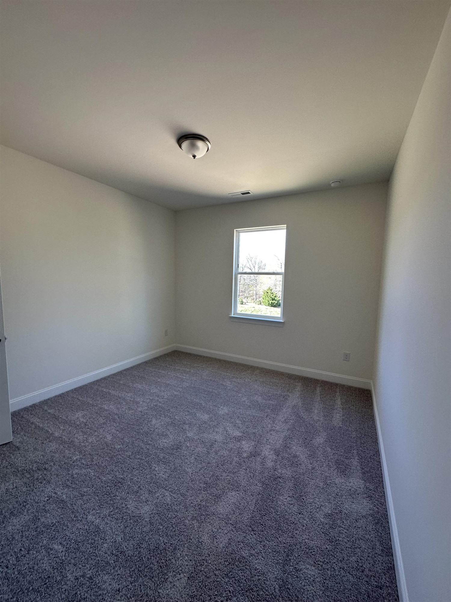 4304 Beckel Road Willow Spring, NC 27592 - Photo 12 of 28 an empty room with windows