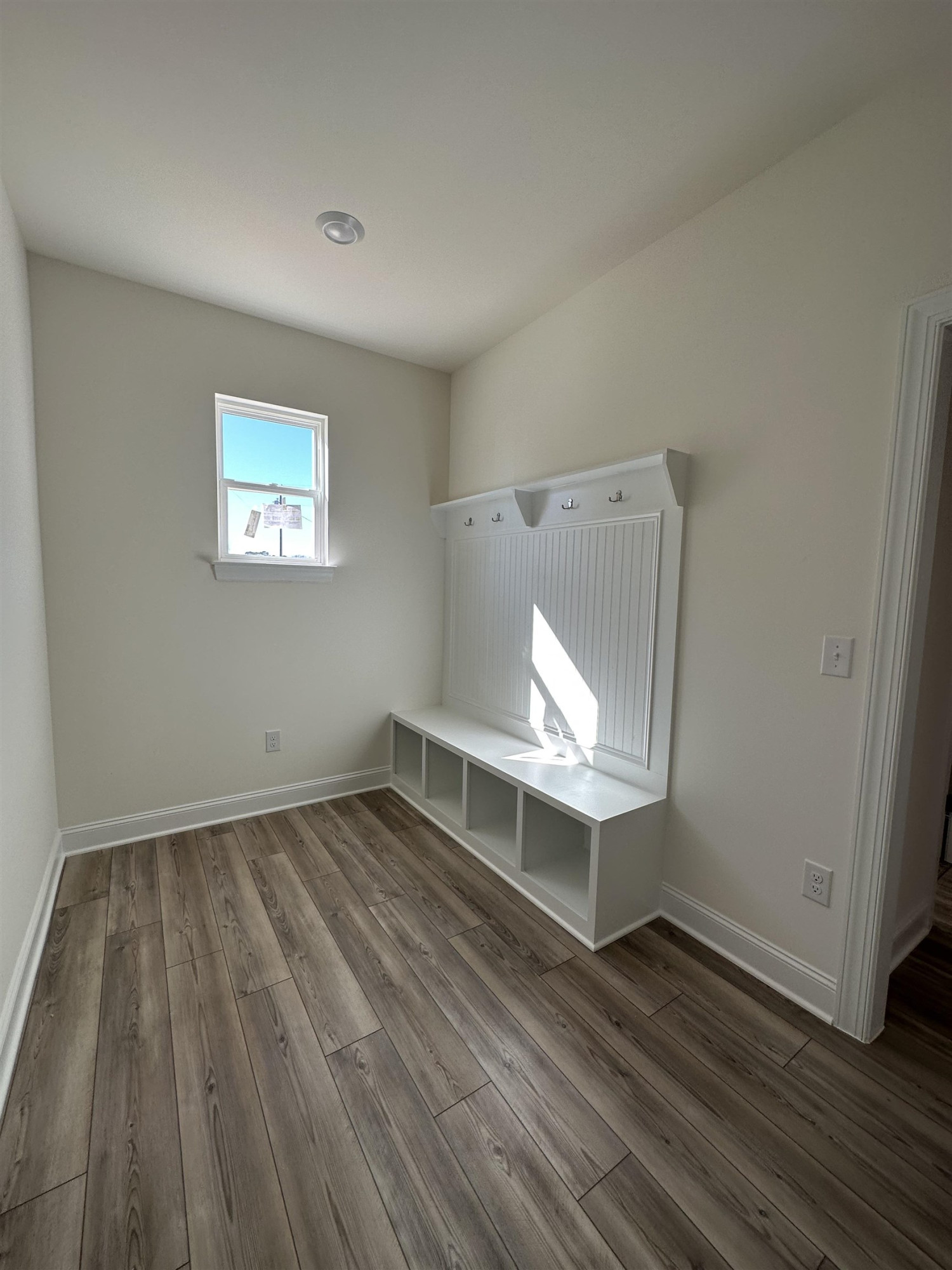 4304 Beckel Road Willow Spring, NC 27592 - Photo 14 of 28 an empty room with wooden floor and window