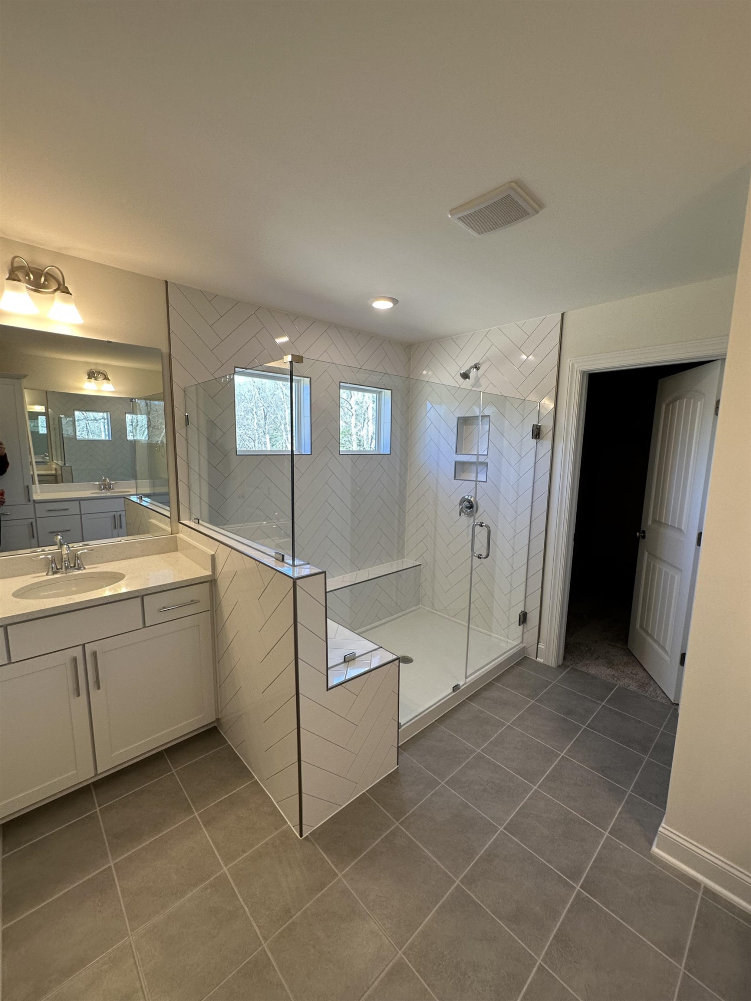 4304 Beckel Road Willow Spring, NC 27592 - Photo 22 of 28 a bathroom with a sink a toilet and mirror