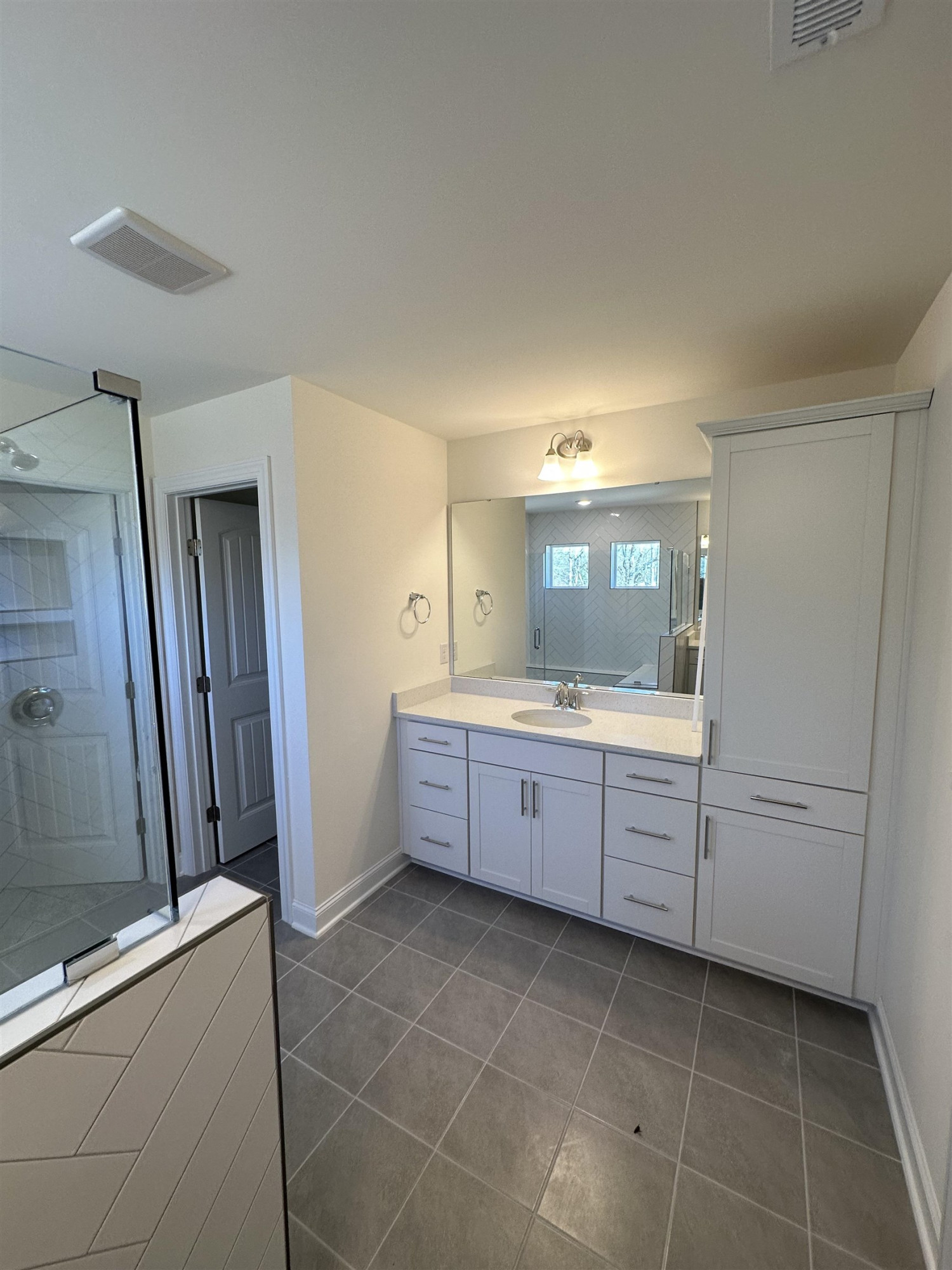 4304 Beckel Road Willow Spring, NC 27592 - Photo 23 of 28 a large bathroom with a double vanity sink a mirror and a bathtub