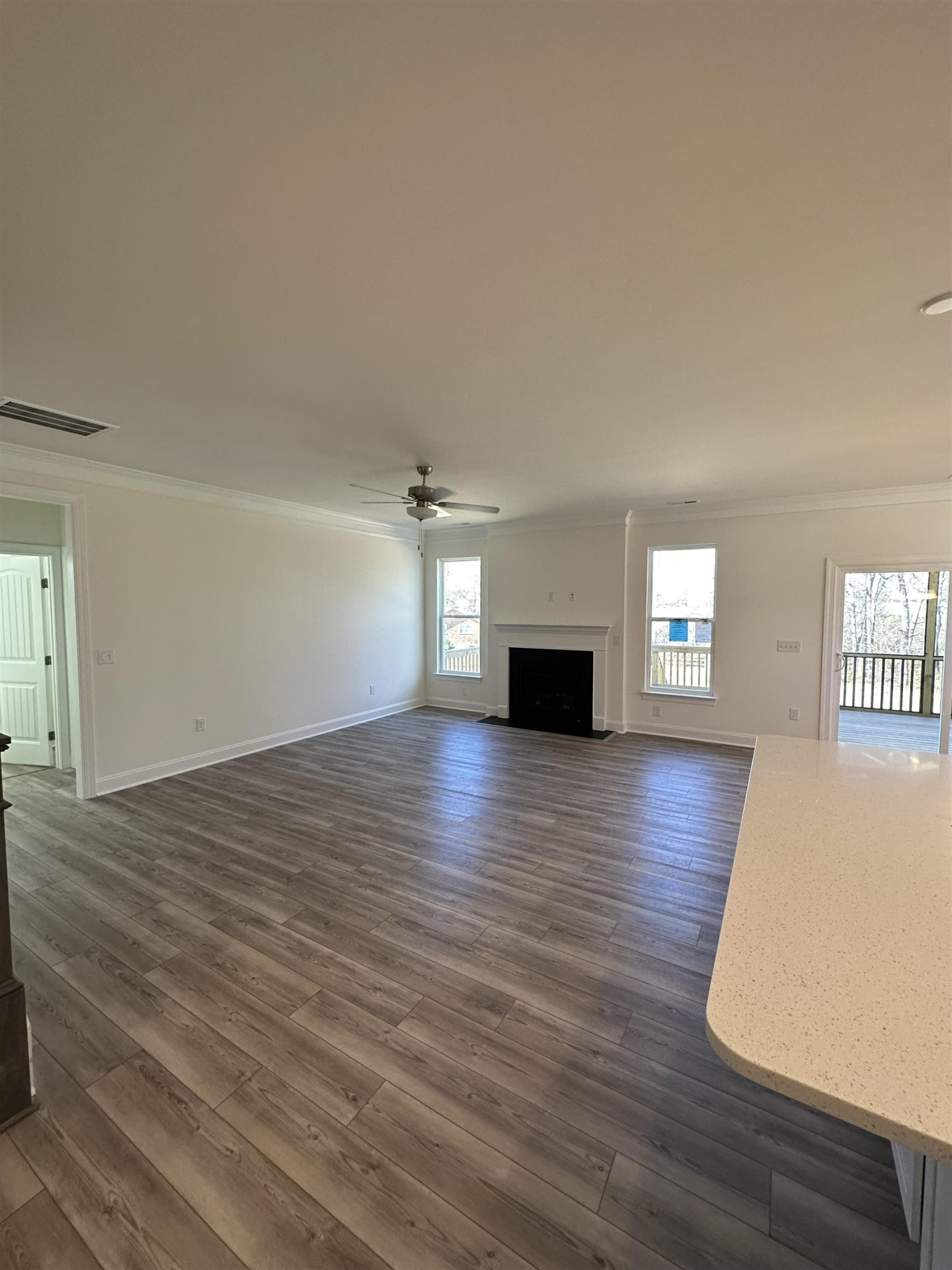 4304 Beckel Road Willow Spring, NC 27592 - Photo 4 of 28 a view of empty room with wooden floor and fireplace