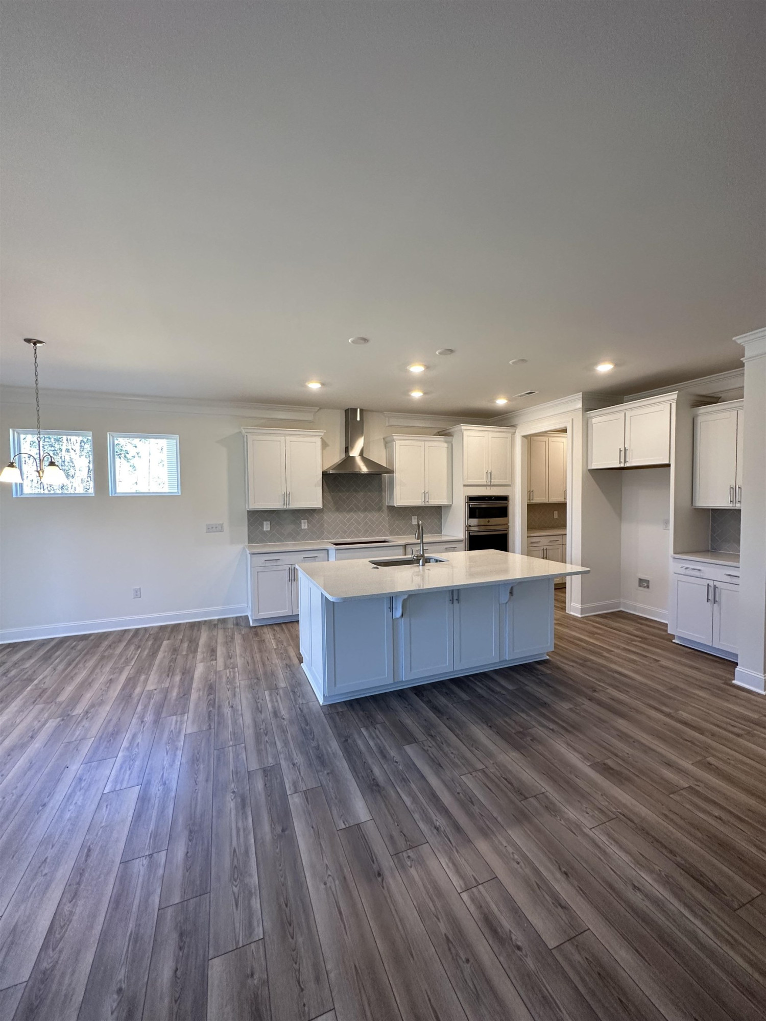 4304 Beckel Road Willow Spring, NC 27592 - Photo 5 of 28 a large kitchen with stainless steel appliances granite countertop a large counter top a stove and a wooden floors