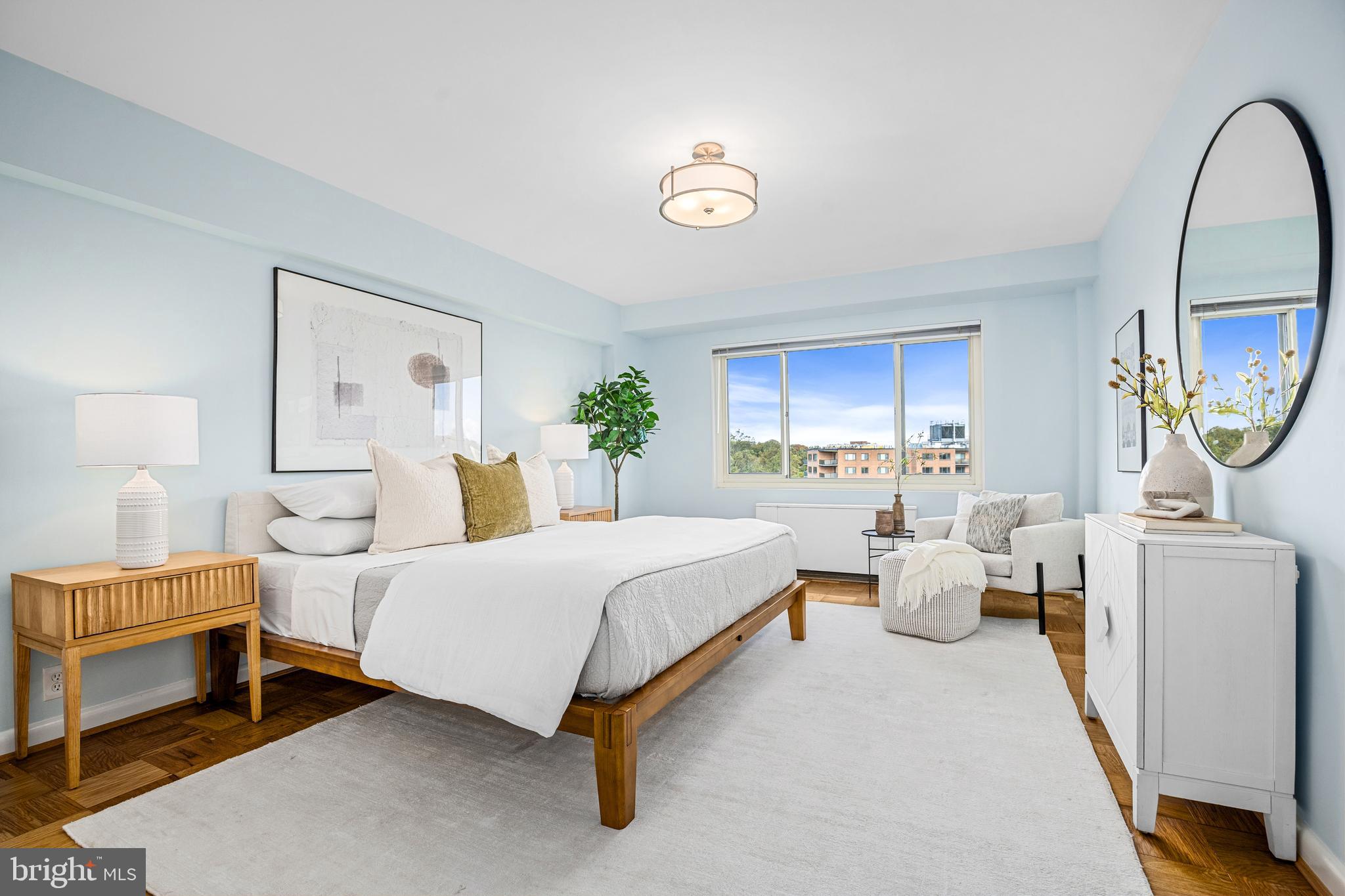 4201 Cathedral Avenue Northwest, Unit 1415W Washington, DC 20016 - Photo 15 of 36 a spacious bedroom with two beds and a chandelier