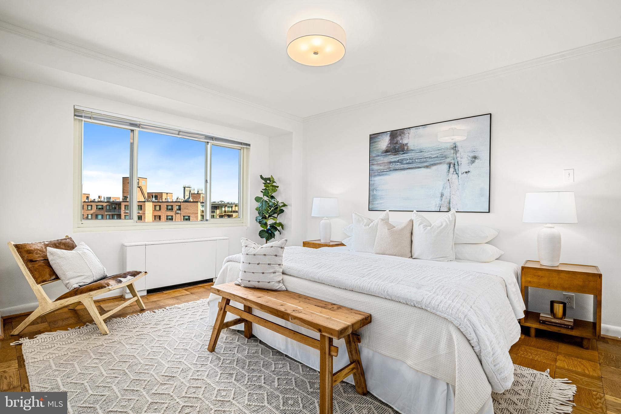 4201 Cathedral Avenue Northwest, Unit 1415W Washington, DC 20016 - Photo 18 of 36 a bedroom with a bed and a desk