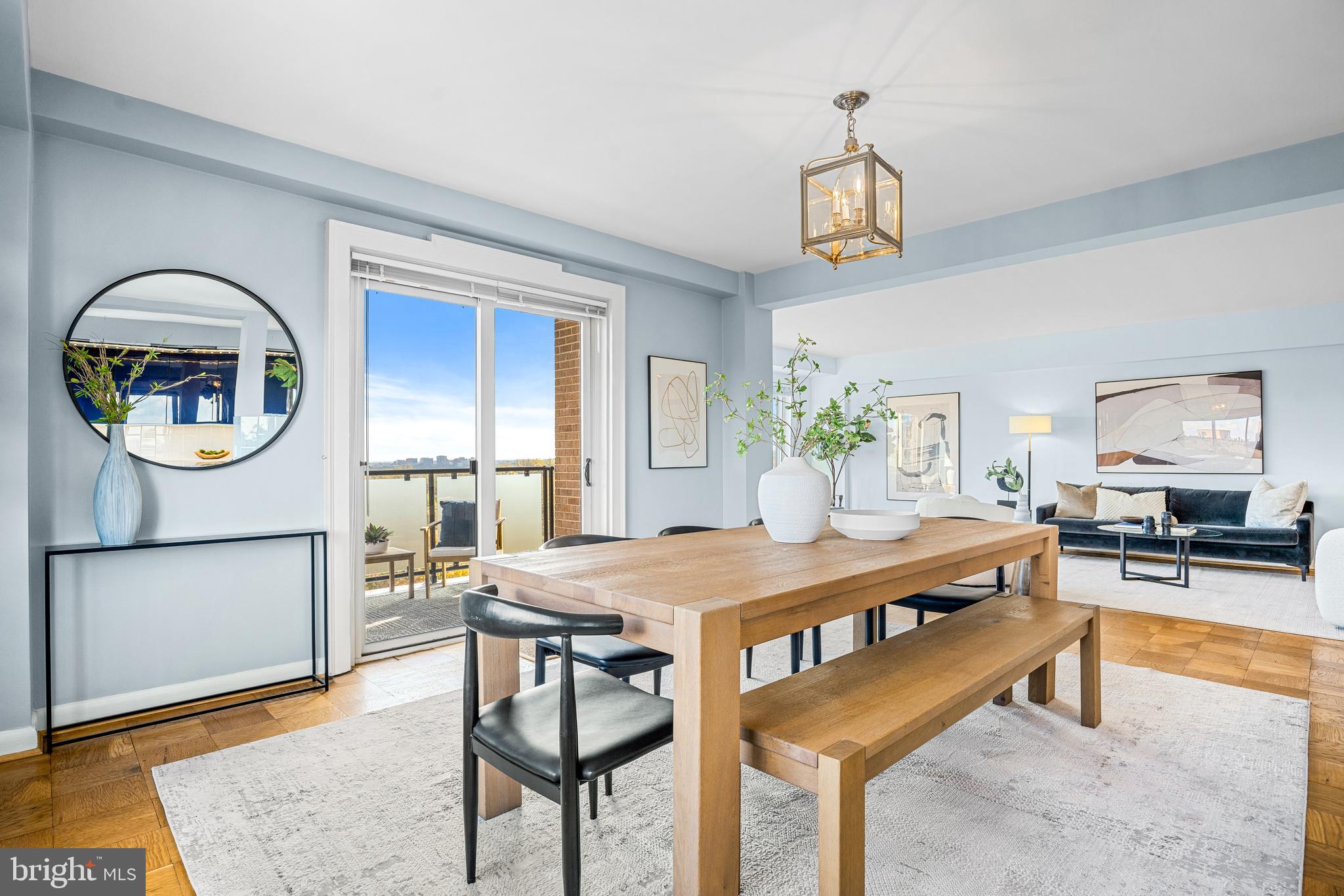 4201 Cathedral Avenue Northwest, Unit 1415W Washington, DC 20016 - Photo 10 of 36 a view of a dining room with furniture and a chandelier
