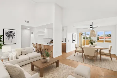 a living room with furniture and a dining table with kitchen view