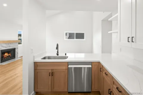 a kitchen with a sink and a stove top oven
