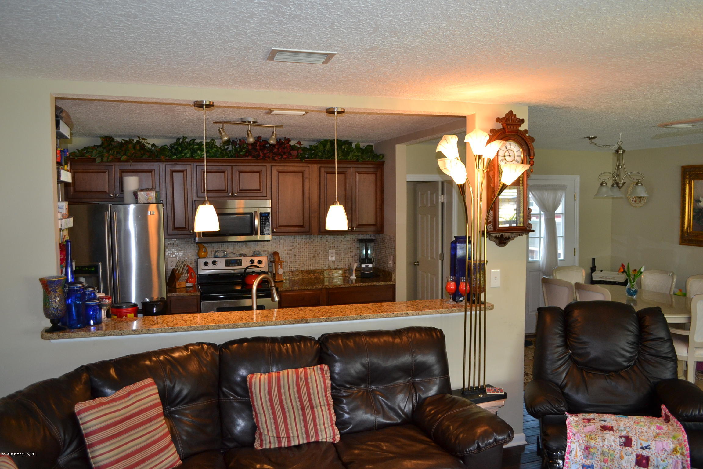 6720 E Road Jacksonville, FL 32216 - Photo 2 of 16 a living room with furniture and chandelier