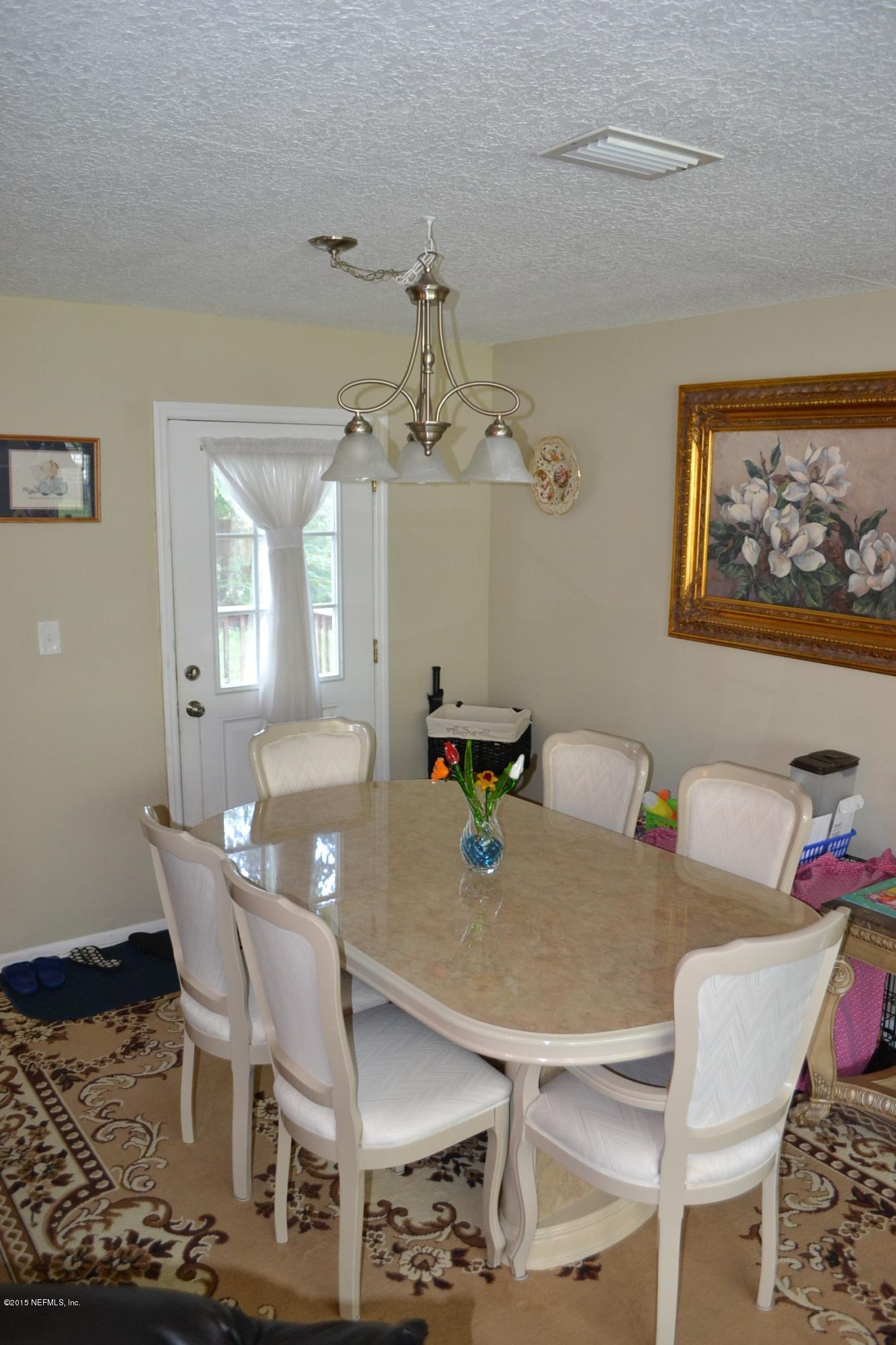 6720 E Road Jacksonville, FL 32216 - Photo 4 of 16 a view of a dining room with furniture and wooden floor