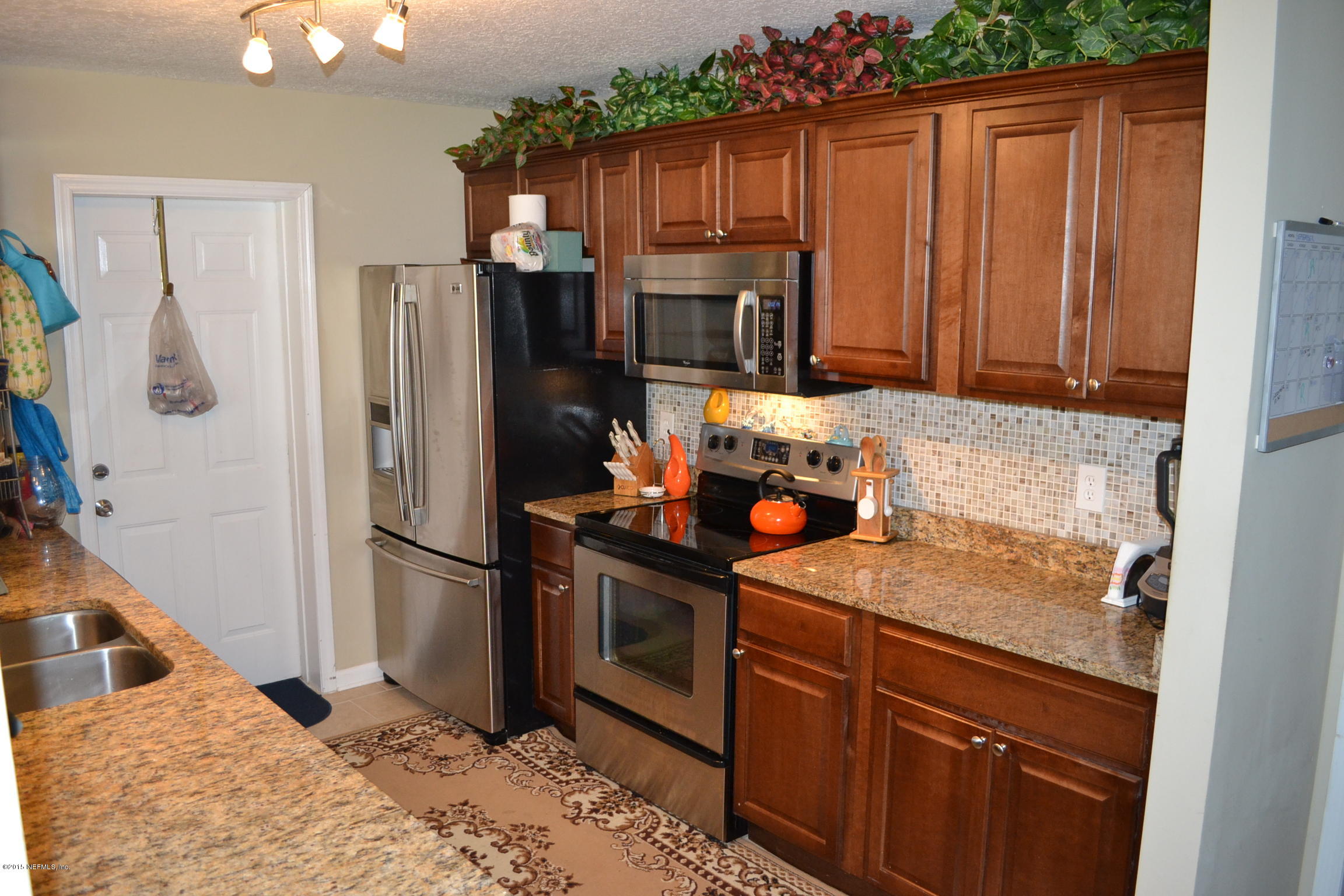 6720 E Road Jacksonville, FL 32216 - Photo 5 of 16 a kitchen with a refrigerator sink and cabinets