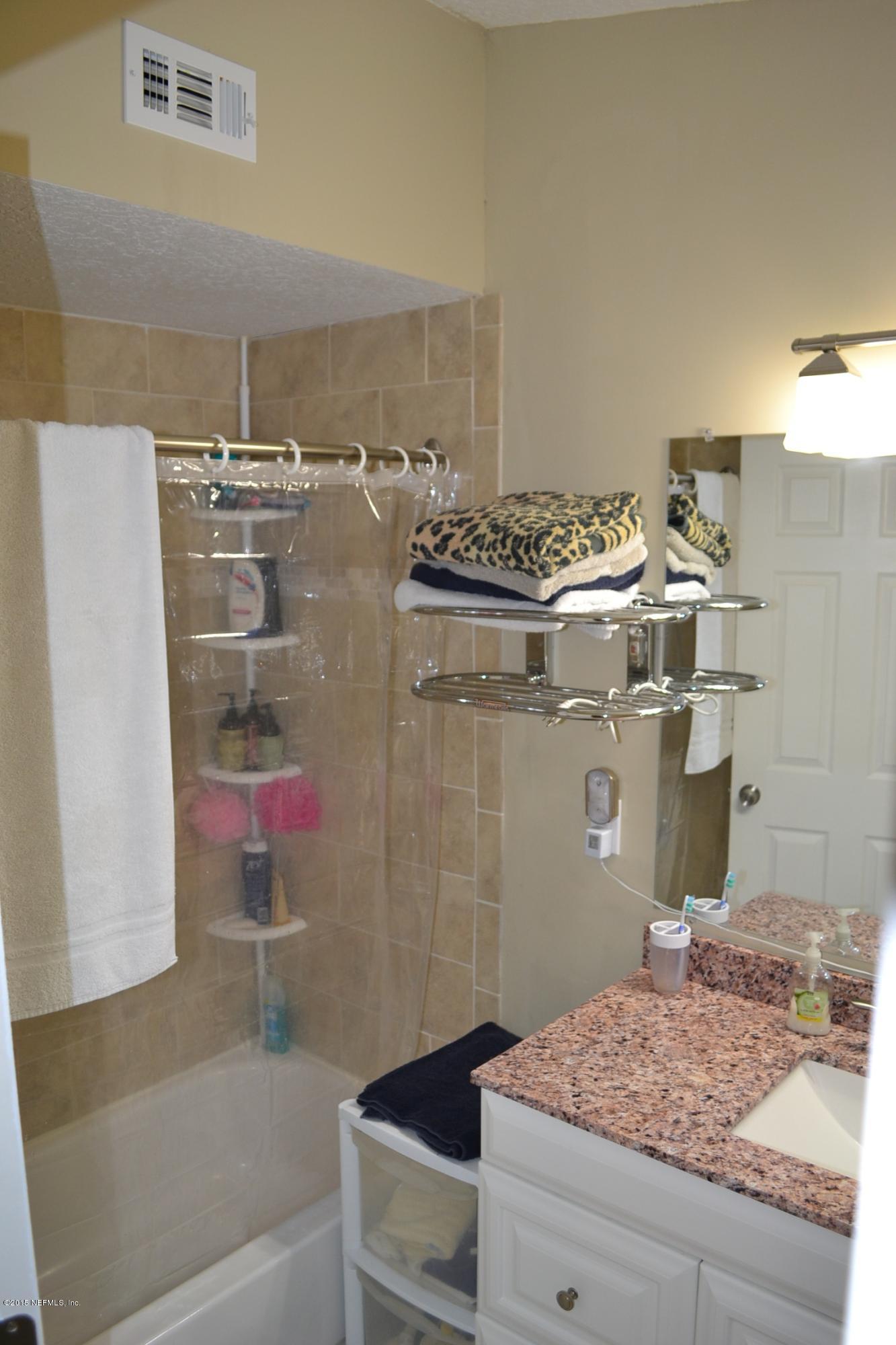 6720 E Road Jacksonville, FL 32216 - Photo 8 of 16 a bathroom with a granite countertop sink and a mirror