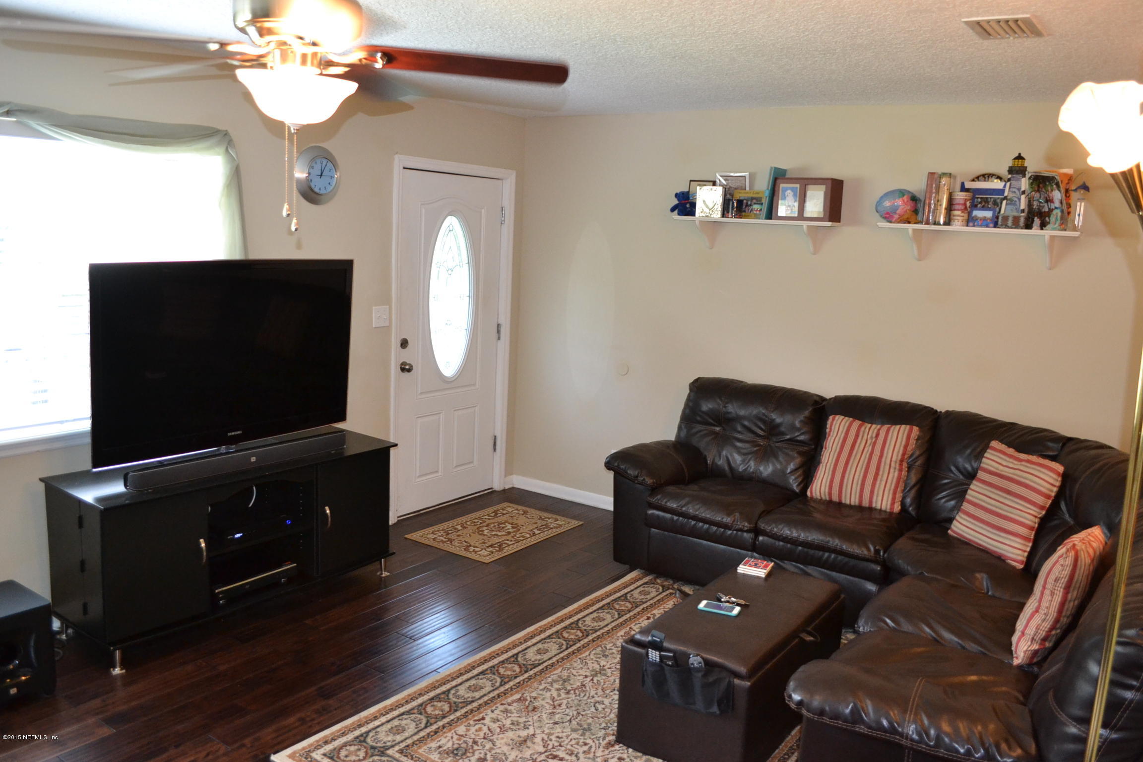 6720 E Road Jacksonville, FL 32216 - Photo 9 of 16 a living room with furniture and a flat screen tv